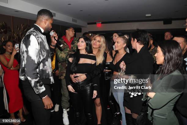Tristan Thompson blows out his birthday candles as Khloe Kardashian, Kylie Jenner, Kris Jenner, Kourtney Kardashian and friends look on at Remy...
