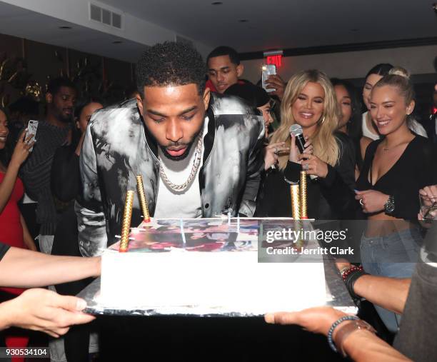 Tristan Thompson blows out his birthday candles as Khloe Kardashian and friends look on at Remy Martin Presents Tristan Thompson's Birthday at Beauty...