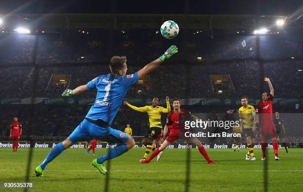 Michy Batshuayi of Dortmund scores his team's third goal against goalkeeper Lukas Hradecky of Frankfurt during the Bundesliga match between Borussia...