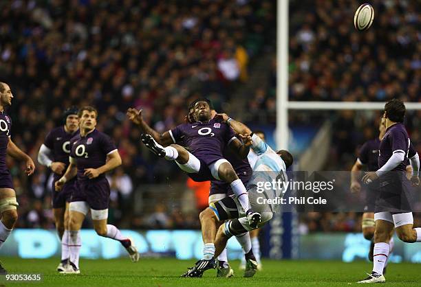 Ugo Monye of England misses a high catch under pressure from Juan Martin Fernandez Lobbe of Argentina during the Investec Challenge match between...