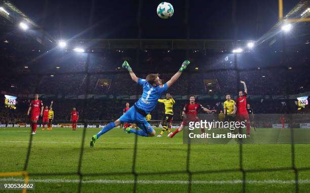 Michy Batshuayi of Dortmund scores his team's third goal against goalkeeper Lukas Hradecky of Frankfurt during the Bundesliga match between Borussia...