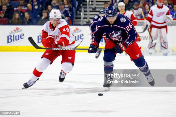 Gustav Nyquist of the Detroit Red Wings and Thomas Vanek of the Columbus Blue Jackets battle for control of the puck during the game on March 9, 2018...