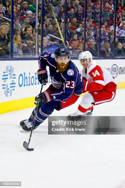 Ian Cole of the Columbus Blue Jackets skates the puck away from Gustav Nyquist of the Detroit Red Wings during the game on March 9, 2018 at...