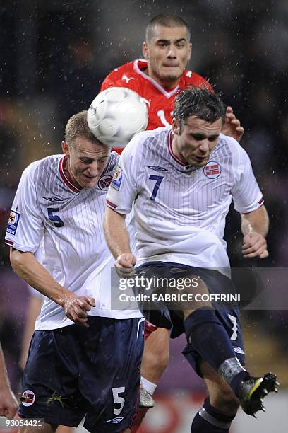 Swiss forward Eren Derdiyok vies behind Norwegian defender Brede Hangeland and teammate Kristofer Haestad Norwegian during their Switzerland vs...