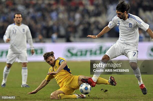 Ukraine's Andriy Shevchenko fights for the ball with Georgios Samaras during a World Cup 2010 play-off qualification football game in Athens on...