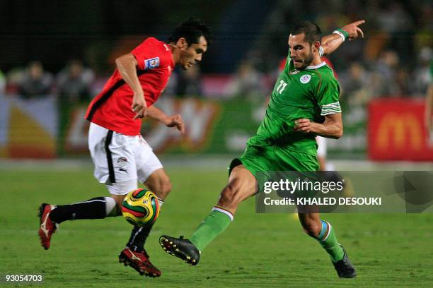 Algeria's Meghni Mowrad tries to intercept Egypt's Ahmed Hassan during their 2010 World Cup African zone group C qualifying football match in Cairo...