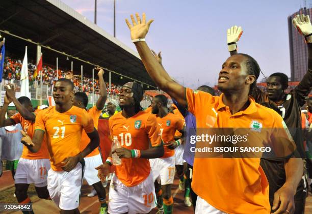 Ivory Coast's National footbal team players Sekou Cisse, Salomon Kalou, Gervais Kouassi Yao, Didier Drogba and Zogbo Aristide celebrate their...