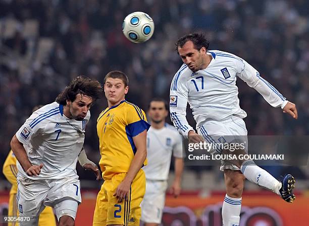 Greece's Theofanis Gekas tries to score past Ukraine's Yaroslav Rakitsky while Greece's Georgios Samaras looks on during their play offs match for...