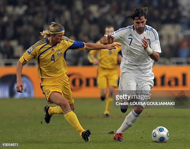 Greece's Giorgios Samaras is challenged by Ukraine's Anatoliy Tymoshchuk during their FIFA World Cup 2010 play-offs football match on November 14,...