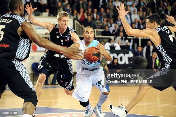 Roanne French guard Marc-Antoine Pellin vies with Orleans American center Ryvon Covile , teammate French forward Justin Doelleman , and French guard...