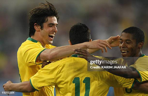 Brazil's Nilmar celebrates with his teammates Kaka and Michel Fernandes Bastos after scoring a goal against England during their friendly football...