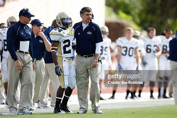 Head coach Paul Johnson of the Georgia Tech Yellow Jackets gives instructions to Embry Peeples during the game against the Duke Blue Devils at...