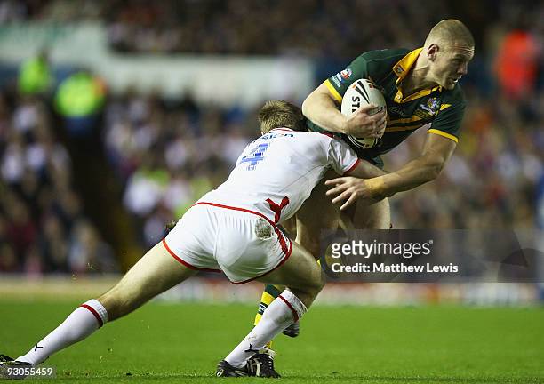 Luke Lewis of Australia is tackled by Michael Shenton of England during the Four Nations Grand Final between England and Australia at Elland Road on...