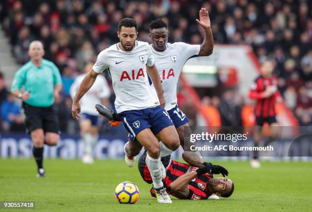 Mousa Dembele of Tottenham Hotspur and Victor Wanyama of Tottenham Hotspur squeeze out Callum Wilson of Bournemouth during the Premier League match...