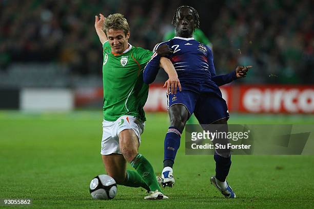 Ireland forward Kevin Doyle battles with Bacary Sagna during the FIFA 2010 World Cup Qualifier play off first leg between Republic of Ireland and...
