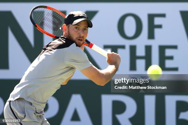 Dudi Sela of Israel returns a shot to Kyle Edmund of Great Britai during the BNP Paribas Open at the Indian Wells Tennis Garden on March 11, 2018 in...