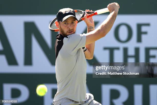 Dudi Sela of Israel returns a shot to Kyle Edmund of Great Britai during the BNP Paribas Open at the Indian Wells Tennis Garden on March 11, 2018 in...