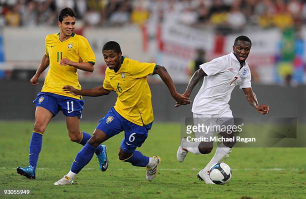 Shaun Wright-Phillips of England takes on Nilmar Honorato Da Silva and Michel Fernandes Bastos during the International Friendly match between Brazil...