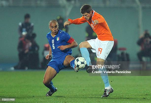 Fabio Cannavaro of Italy challenges for the ball with Klaas-Jan Huntelaar of Holland during the international friendly match between Italy and...