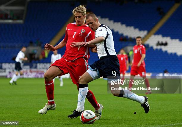 Kenny Miller of Scotland tries to hold off David Edwards of Wales during the International Friendly match between Wales and Scotland at the Cardiff...