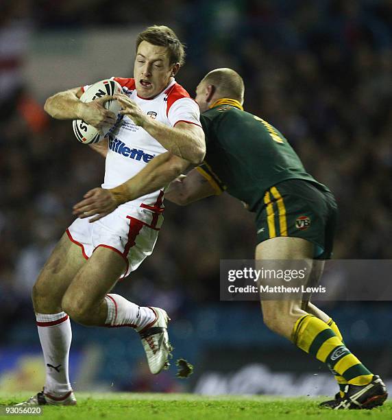 James Roby of England is tackled by Luke Lewis of Australia during the Four Nations Grand Final between England and Australia at Elland Road on...