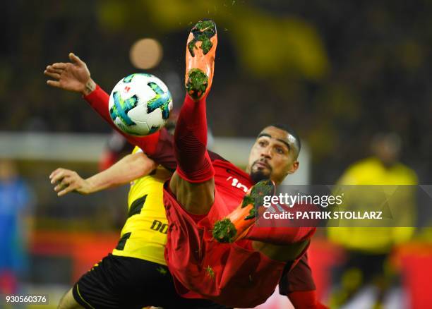 Frankfurt's Ghanaian midfielder Kevin-Prince Boateng and Dortmund's German defender Marcel Schmelzer vie for the ball during the German first...