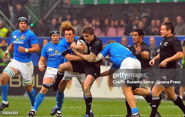 Mirco Bergamasco and Martin Castrogiovanni tackle Mike Delany during the international match between Italy and New Zealand at the San Siro Stadium on...