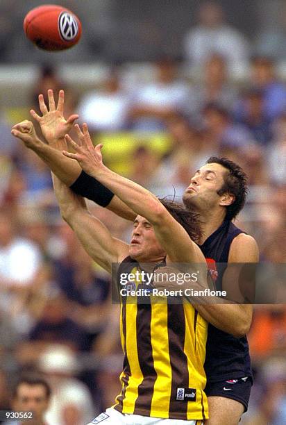 Trent Croad of Hawthorn has his mark spoiled by Glenn Manton of Carlton, during the match between the Carlton Blues and the Hawthorn Hawks, during...