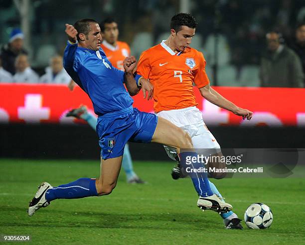 Giorgiio Chiellini of Italy tackles Robin van Persie of Holland during the international friendly match between Italy and Holland at Adriatico...