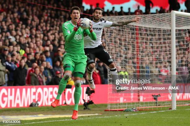 Costel Pantilimon of Nottingham Forest and Bradley Johnson of Derby County during the Sky Bet Championship match between Nottingham Forest and Derby...