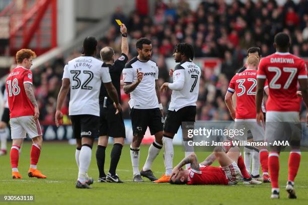 Tom Huddlestone of Derby County is booked for a foul on Lee Tomlin of Nottingham Forest during the Sky Bet Championship match between Nottingham...
