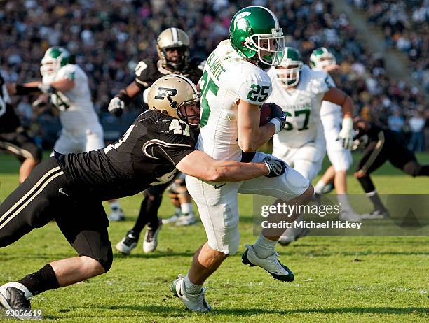 Blair White of the Michigan State Spartans is hit from behind by Chris Carlino of the Purdue Boilermakers and will go on to score a touchdown at...