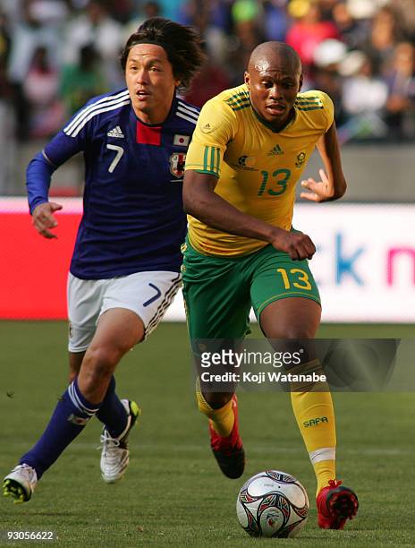 Kagisho Dikgacoi of South Africa and Yasuhito Endo of Japan compete for the ball during the international friendly match between South Africa and...