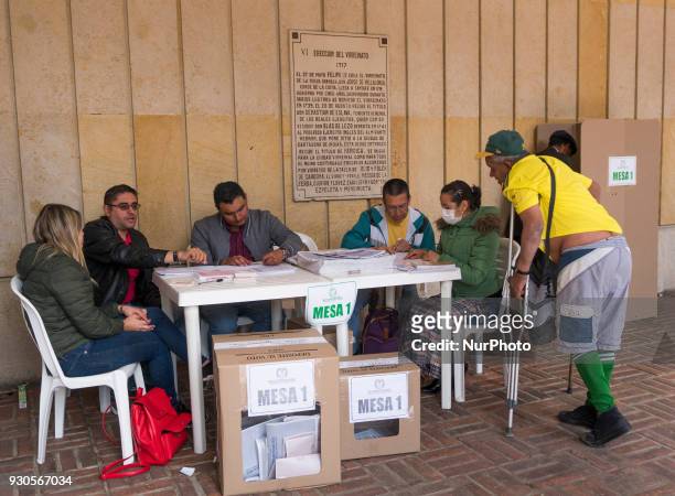 Man using crutches votes at a polling station during Colombian parliamentary elections at Congress of Colombia in Bogota, Colombia on March 11, 2018.