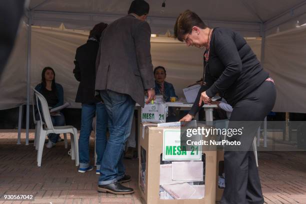 The colombian people votevote at a polling station during Colombian parliamentary elections at Congress of Colombia in Bogota, Colombia on March 11,...