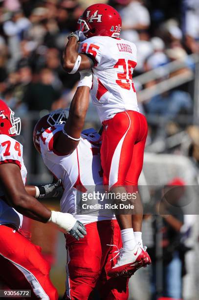 Right guard Chris Thompson of the Houston Cougars celebrates with wide receiver Tyron Carrier, after Carrier scores a first quarter touchdown against...
