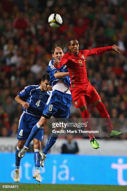 Liedson of Portugal tangles with Sanel Jahic of Bosnia during the FIFA 2010 European World Cup qualifier first leg match between Portugal and...