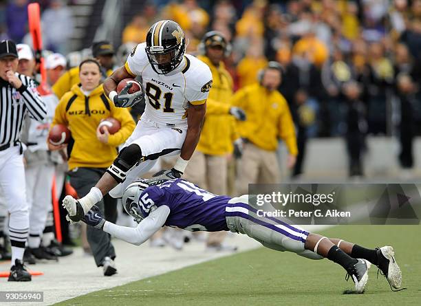 Wide receiver Danario Alexander of the Missouri Tigers leaps over defensive back Darious Thomas of the Kansas State Wildcats along the sidelines in...