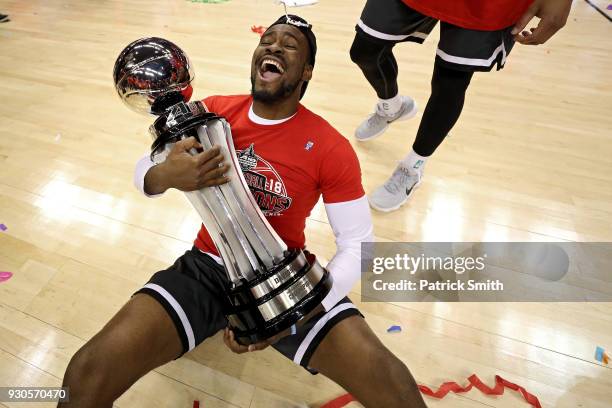 Nathan Ekwu of the Davidson Wildcats celebrates with the trophy after defeating the Rhode Island Rams in the Championship of the Atlantic 10...