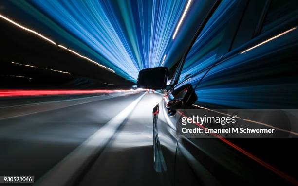 black german car drives fast on autobahn - autorennen stock-fotos und bilder