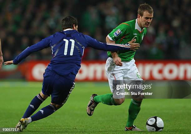 Ireland player Glenn Whelan is stopped by France player Andre-Pierre Gignac during the FIFA 2010 World Cup Qualifier play off first leg between...