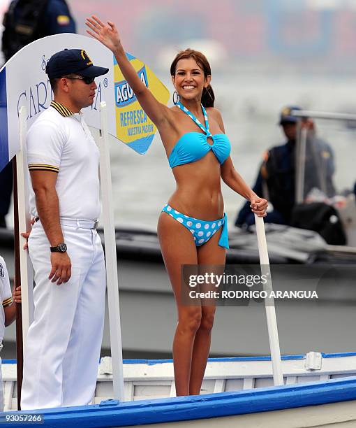 Cartagena department's contestant Veronica Avila waves during the "Desfile en Balleneras" in Cartagena, Colombia, on November 14 prior to Miss...