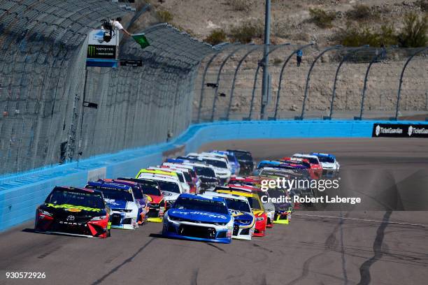 Martin Truex Jr., driver of the 5-hour Energy/Bass Pro Shops Toyota, leads the field past the green flag to start the Monster Energy NASCAR Cup...