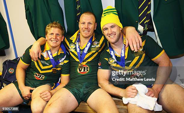 Ben Hannant, Luke Lewis and Paul Gallen of the VB Kangaroos Australia Rugby League Team celebrate winning the Four Nations Grand Final between...