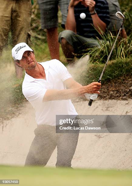 Adam Scott of Australia plays out of a bunker on the 12th hole during round three of the 2009 Australian Masters at Kingston Heath Golf Club on...