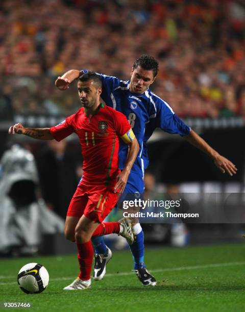 Simao Sabrosa of Portugal tangles with Sanel Jahic of Bosnia during the FIFA 2010 European World Cup qualifier first leg match between Portugal and...