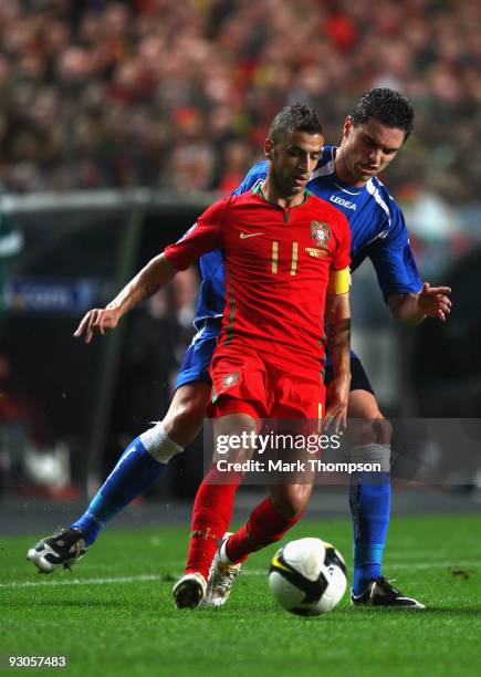 Simao Sabrosa of Portugal tangles with Sanel Jahic of Bosnia during the FIFA 2010 European World Cup qualifier first leg match between Portugal and...