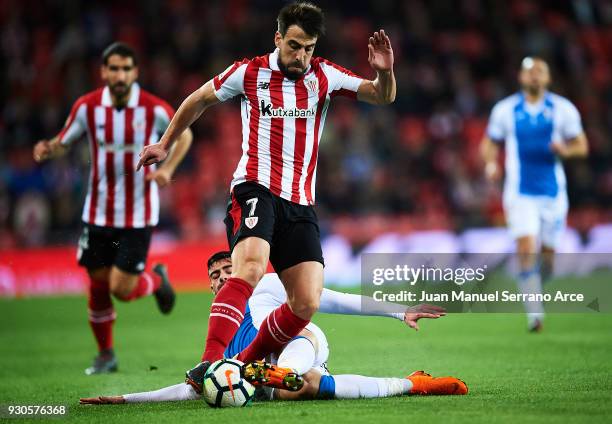 Benat Etxebarria of Athletic Club competes for the ball with Diego Rico of Club Deportivo Leganes during the La Liga match between Athletic Club...