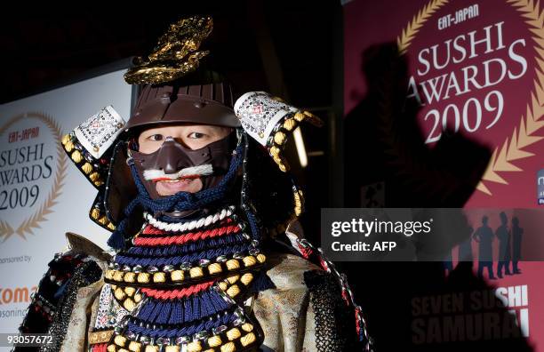 Man dressed in traditional samurai clothing greets guests at the "Seven Sushi Samurai" Sushi of the Year awards 2009 at the Olympia exhibition centre...