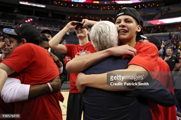 Kellan Grady of the Davidson Wildcats celebrates with coach Bob McKillop after defeating the Rhode Island Rams in the Championship of the Atlantic 10...